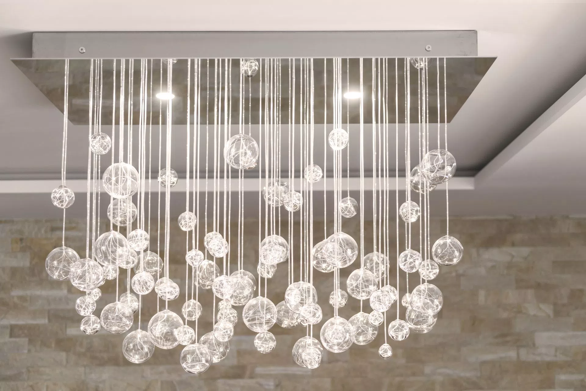 Fiber optic chandelier AQUILA with LED spotlights glowing in the daytime