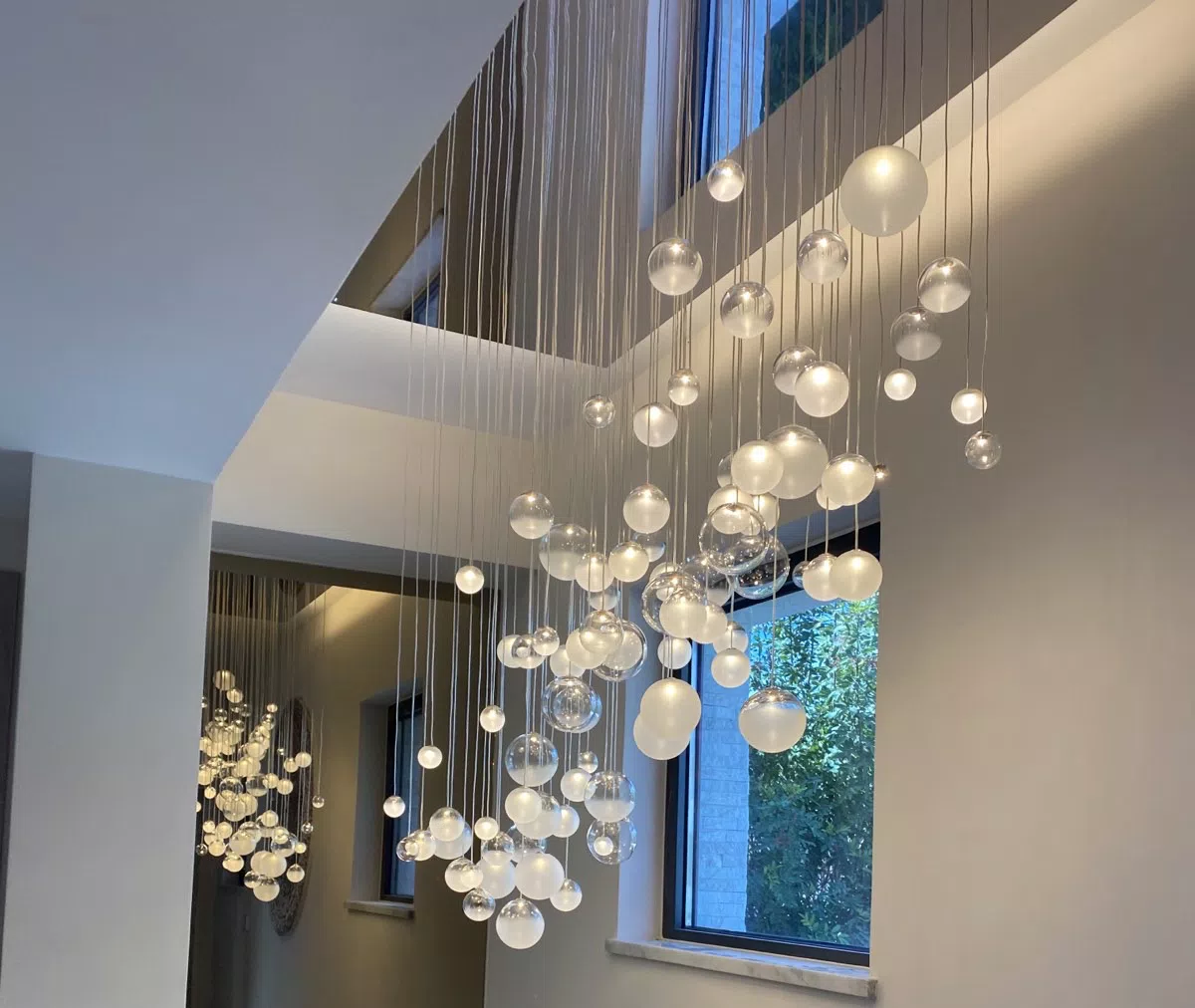 LED glass ball lighting LURE chandelier above staircase