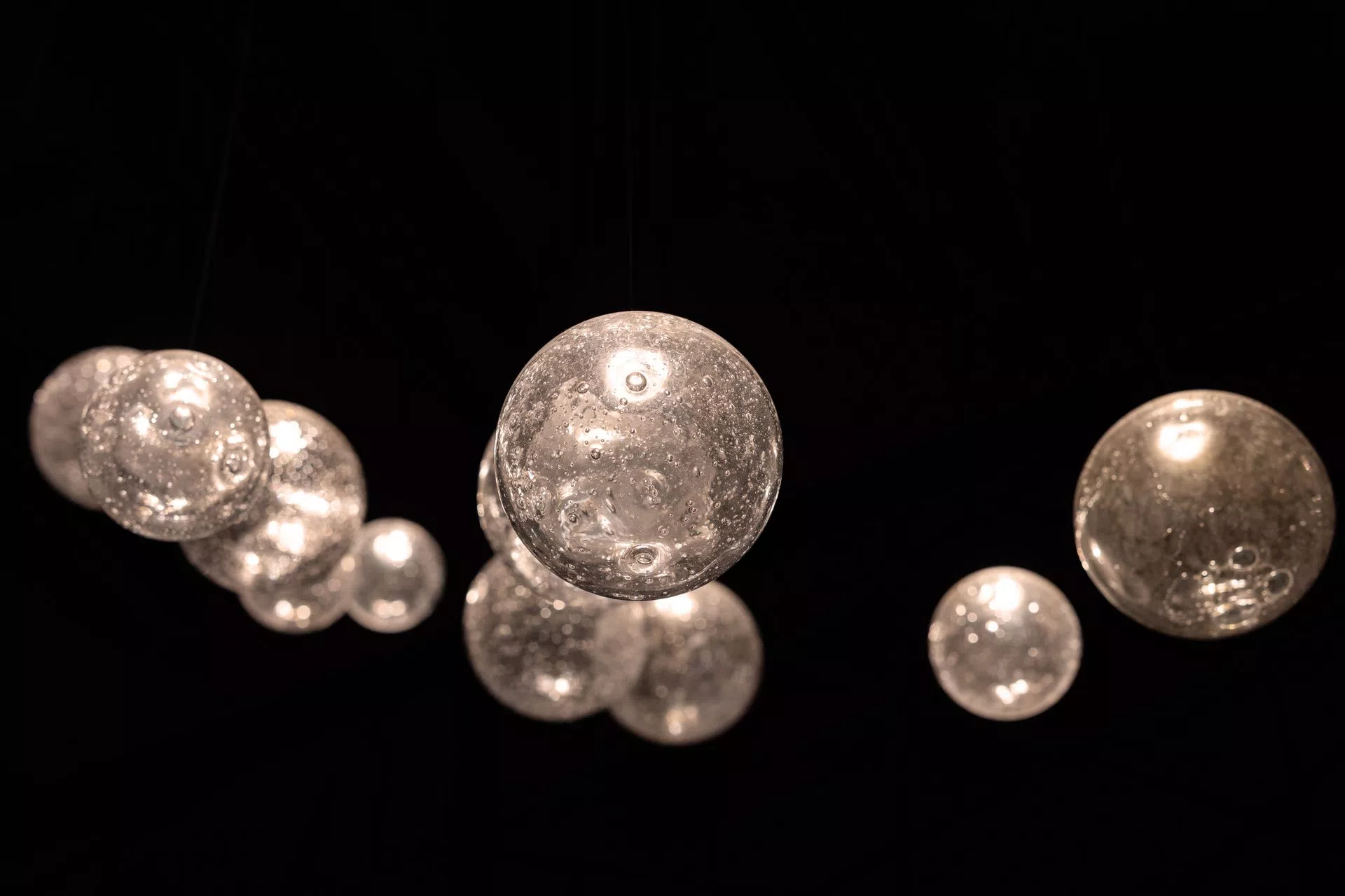 Eluda glass ball detail from bellow, soda glass balls contain tinz bubles, enlighted by LED system, creating beautifull sparkles.