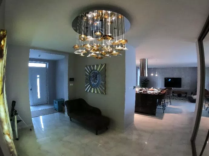 Entrance hall chandelier in private residence with turned on fibre optic circuit only