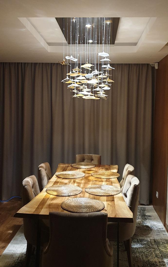 Fiber optic chandelier INFINITO in private dinning room from side