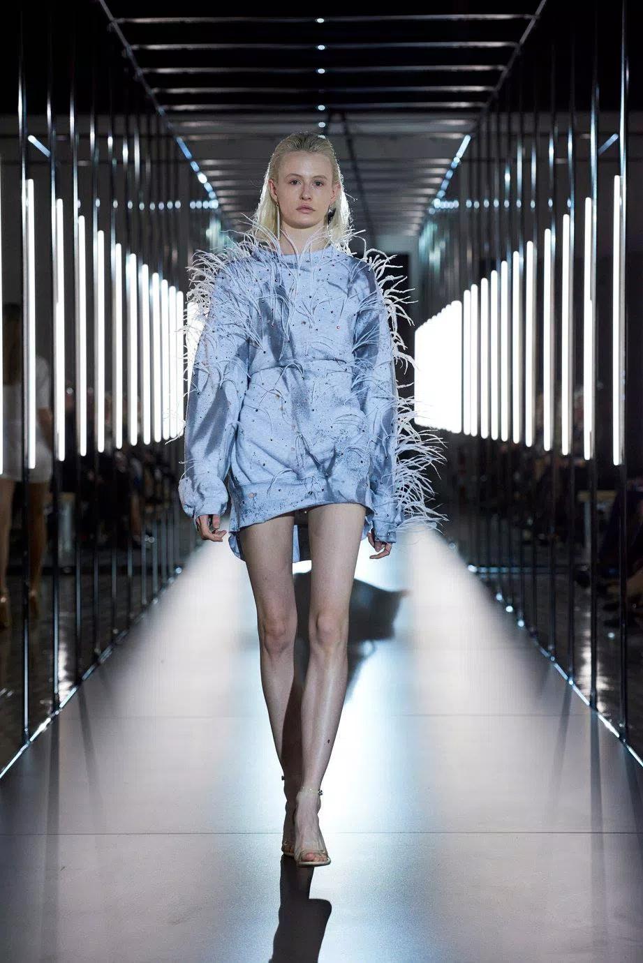 Fashion Model walking through the light parade with linear LED lights