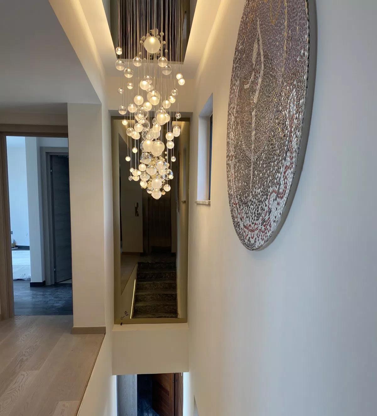 LURE LED chandelier installed above staircase modern villa in cyprus