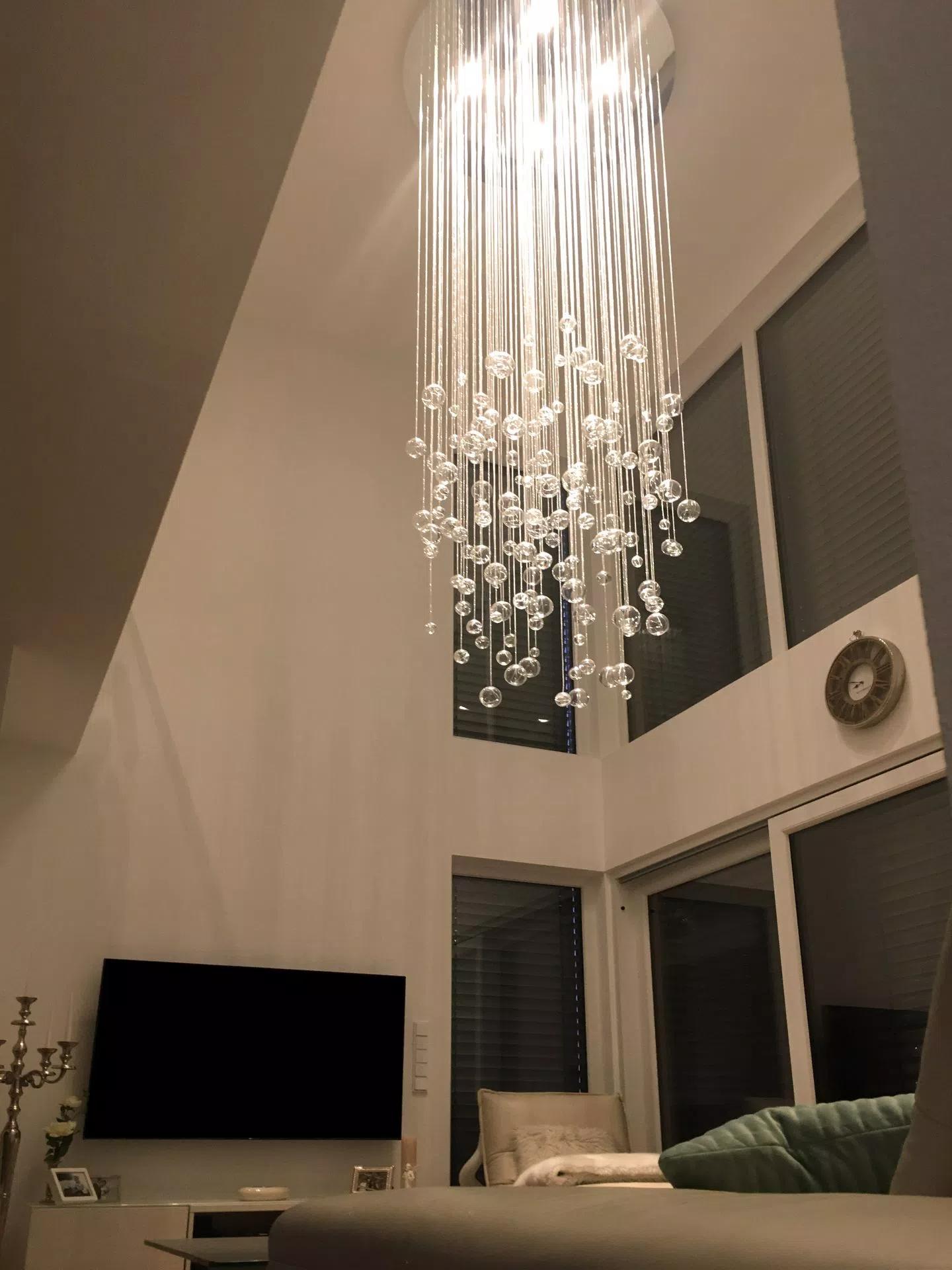 Aquila chandelier in livingroom above sofa