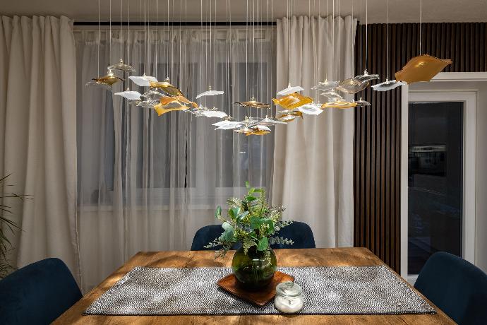 Dining table chandelier INFINITO in private modern house is great for romantic dinners with family or friends.