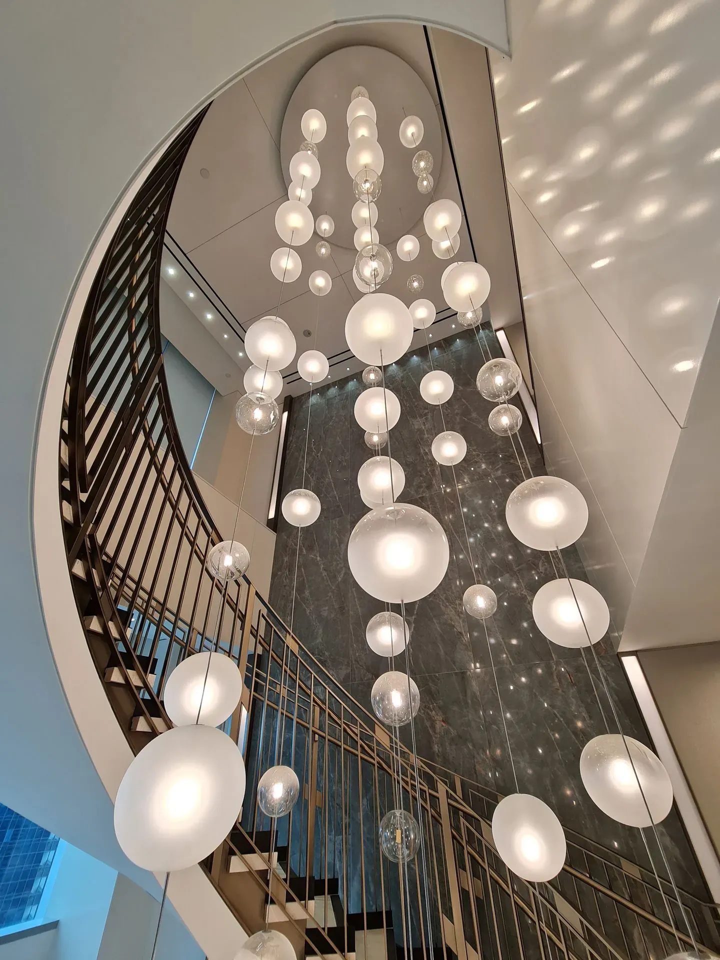 FOSALI tall modular modern LED chandelier on tall staircase in commercial centre or hotel