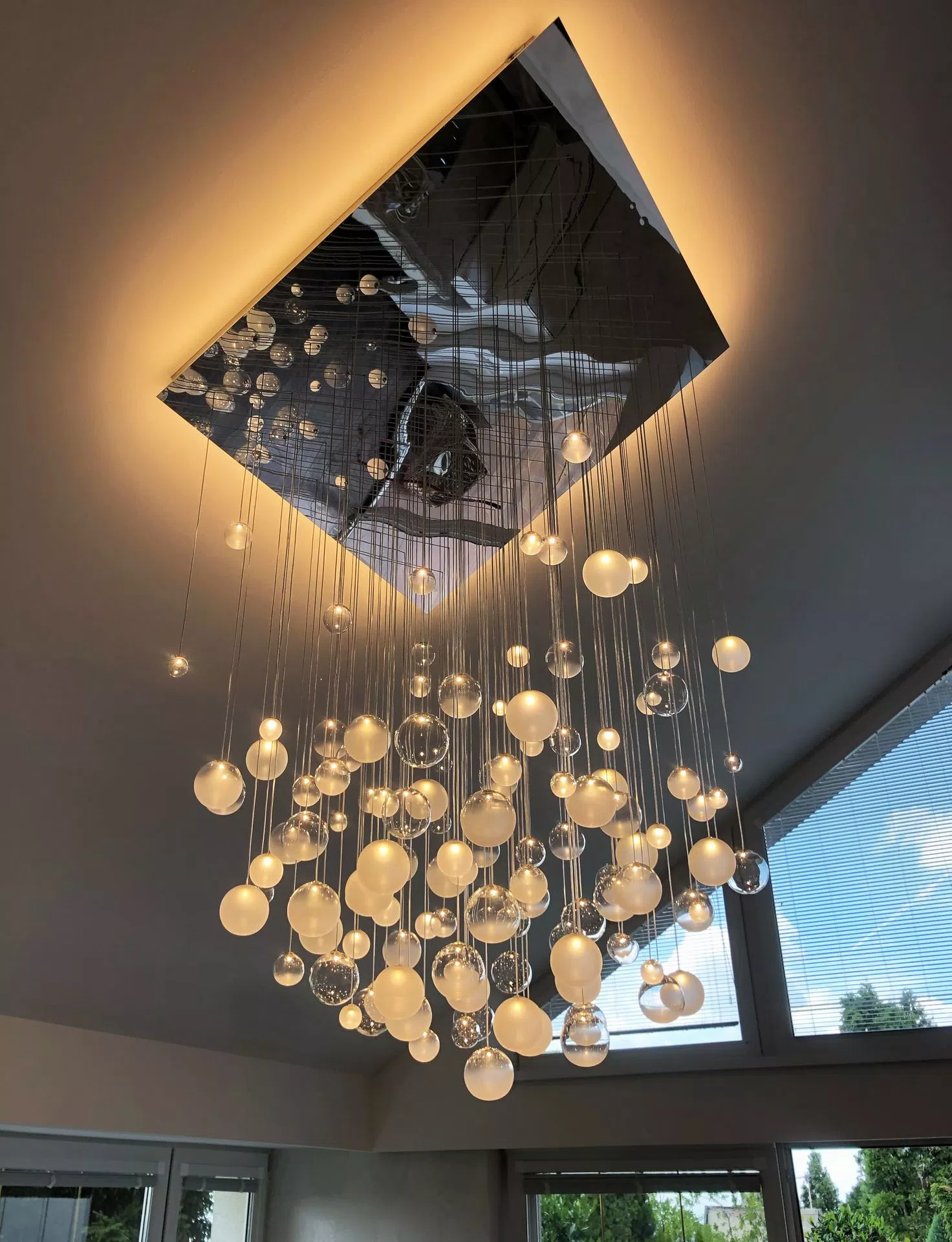 LED chandelier in livingroom with sloped ceiling